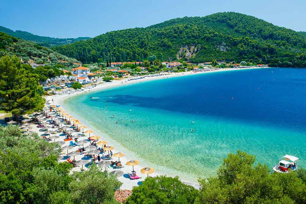 Crystal clear waters at Skopelos Island with a view of mountain