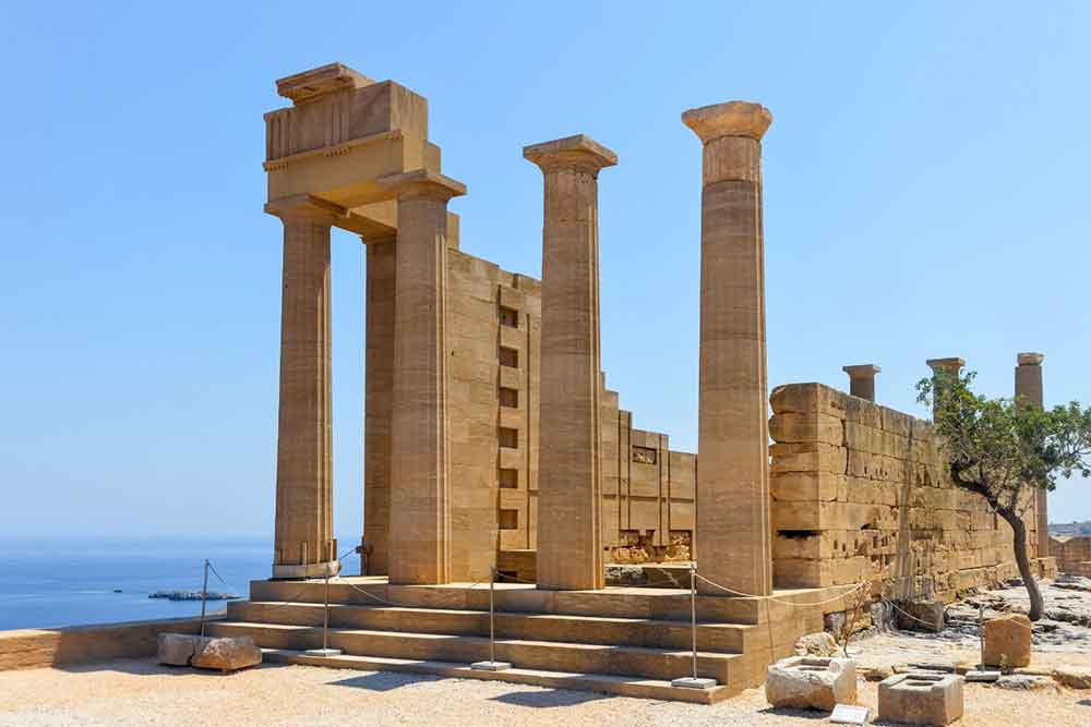 Acropolis of Lindos with an overlooking view of sea on the other side in sunny day