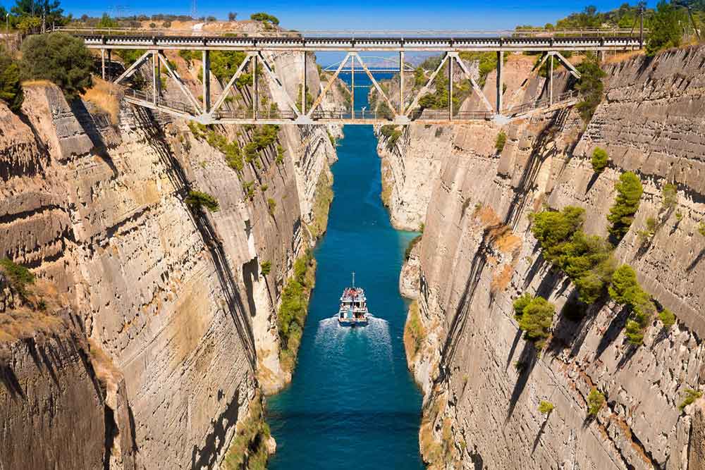 A boat travels in the the middle of Corinth canal 