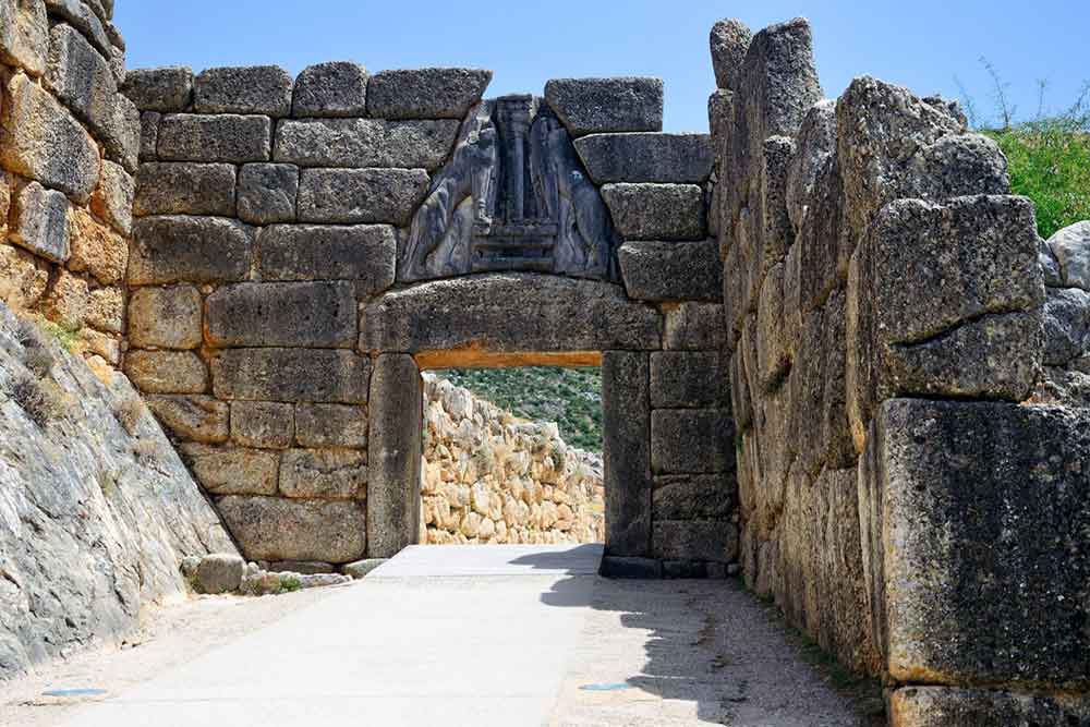 Lion gate at Ancient Mycenae with sculpture of two lions in a heraldic pose standing above the entrance
