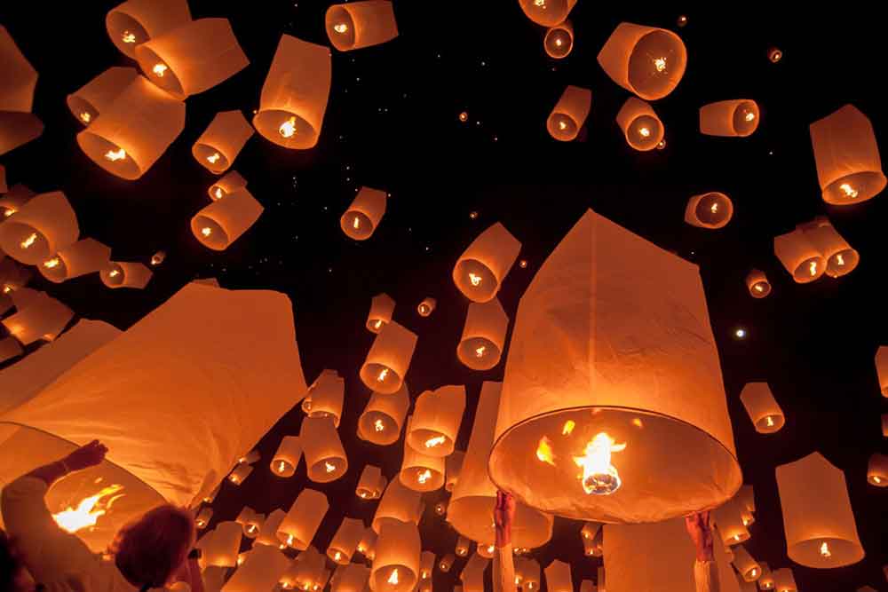 Thousands of lanterns released into the night sky create a mesmerizing display of floating lights at the Yee Peng Festival