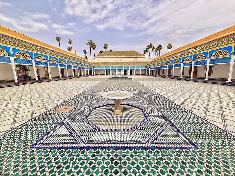 Courtyard at the Bahia Palace with gemoetric tiled floor and a fountain in the middle. 