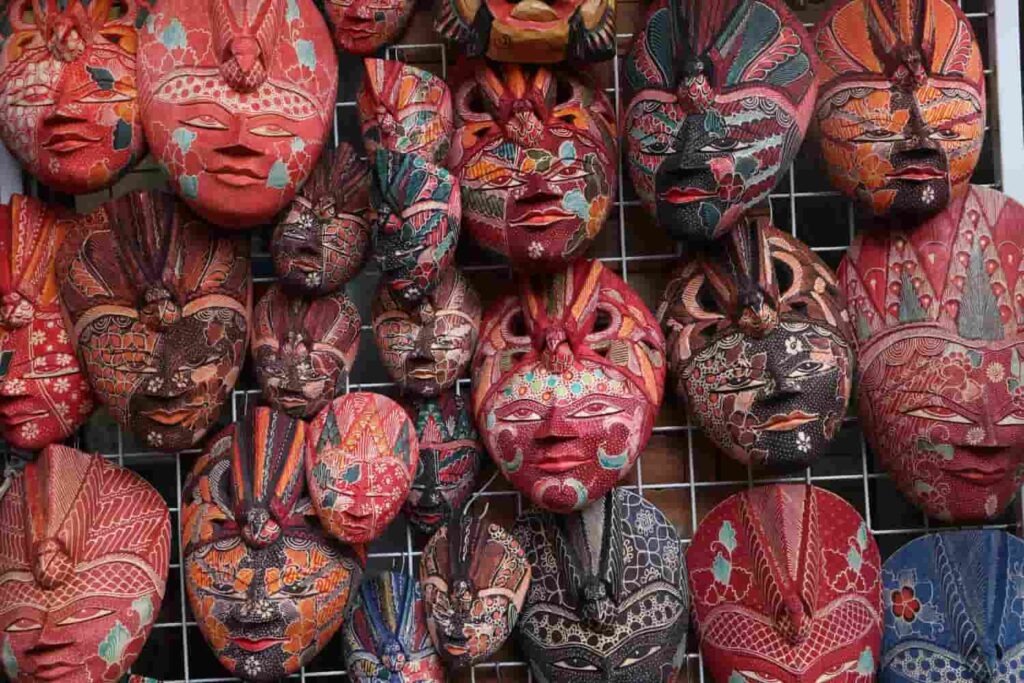 Colorful wooden masks artworks displayed at a shop in Ubud Market