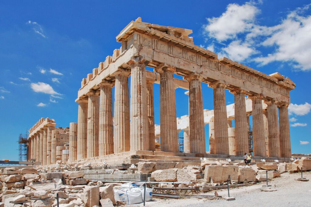 The Parthenon, a majestic structure with a series of columns in a white marble on a sunny day