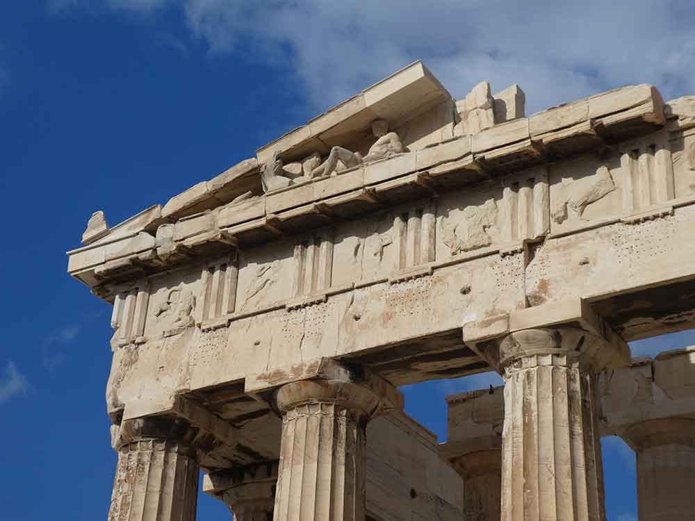 Close up look of Parthenon - a marble temple with detailed sculptures on the roof