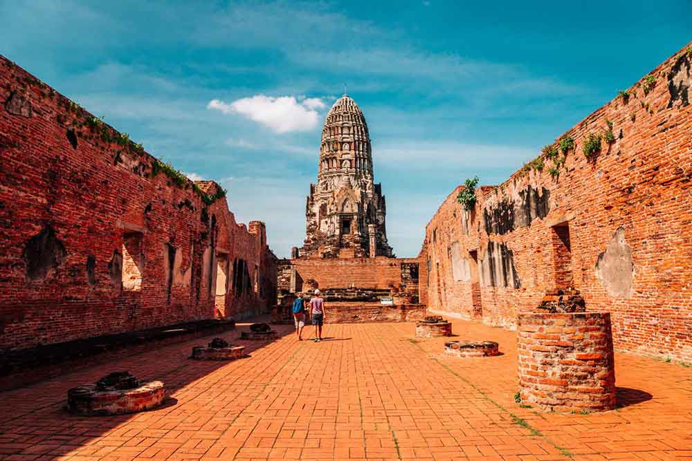 How to Spend a Month in Thailand: Best 1 Month in Thailand Itinerary 9 Two men visiting Wat Ratchaburana in a sunny day