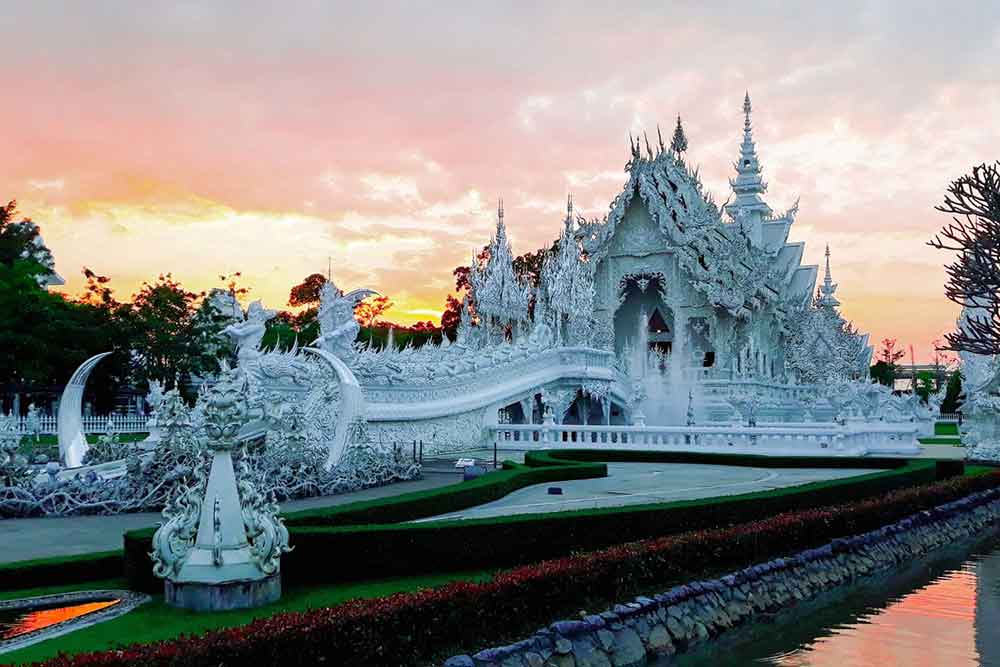 How to Spend a Month in Thailand: Best 1 Month in Thailand Itinerary 16 Wat Rong Khun or The White Temple at sunset with garden and pond