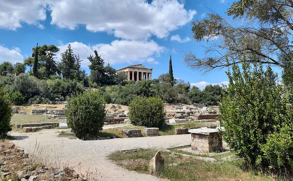 Ancient Agora surrounded by trees in a clear blue sky