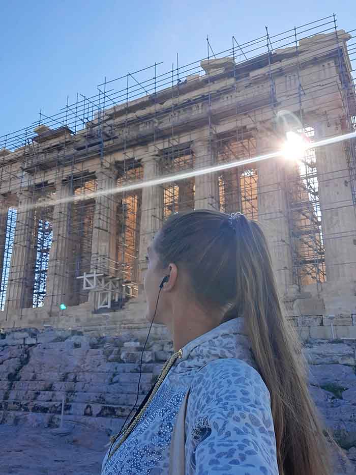 Tour the Acropolis Without the Crowds: Pristine Parthenon Early Morning Acropolis Tour, Athens 13 A woman with a background of renovation of The Parthenon