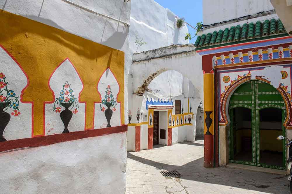 White-washed with a paintings on the walls in the streets of Tetouan on a sunny day