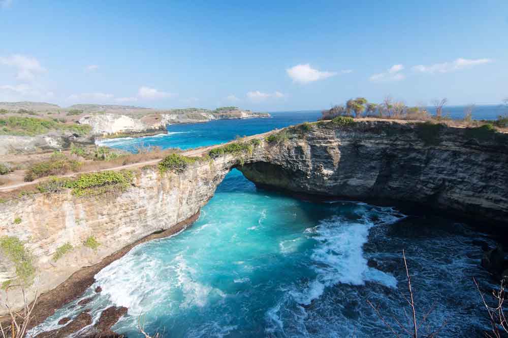Broken Beach, Nusa Penida features a turquoise water with its stunning archway that connects the beach to the sea