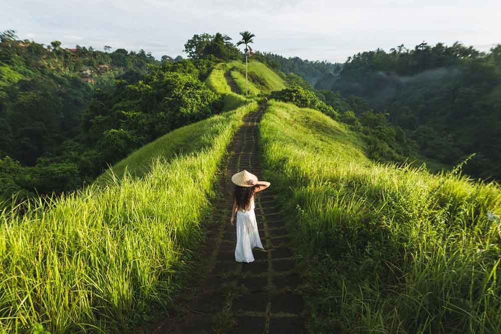 Girl in a white dress and hat on the Campuhan Ridge Walk