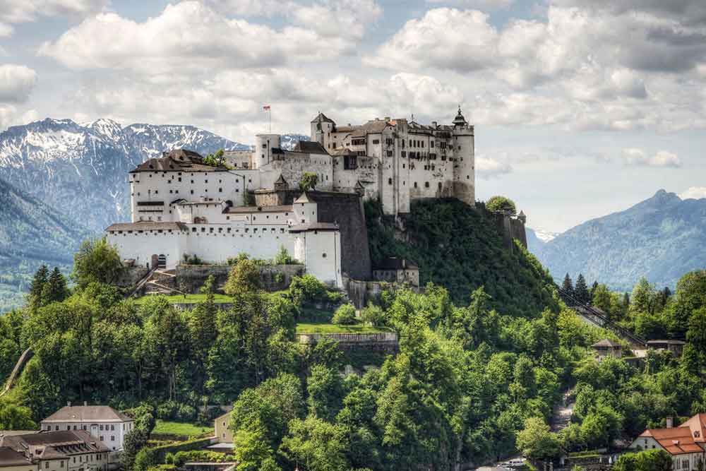 Hohensalzburg Fortress perched on the hill with its massive stone walls and fortified towers offering a great view of mountains