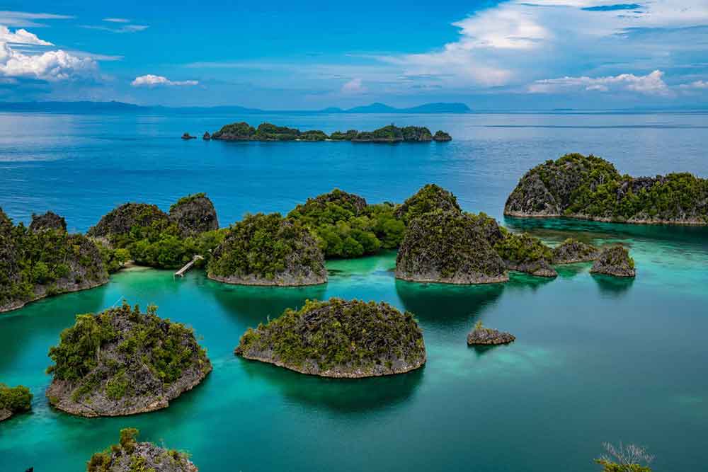 Raja Ampat Islands, West Papua featuring a scattered islands surrounded by crystal-clear turquoise waters