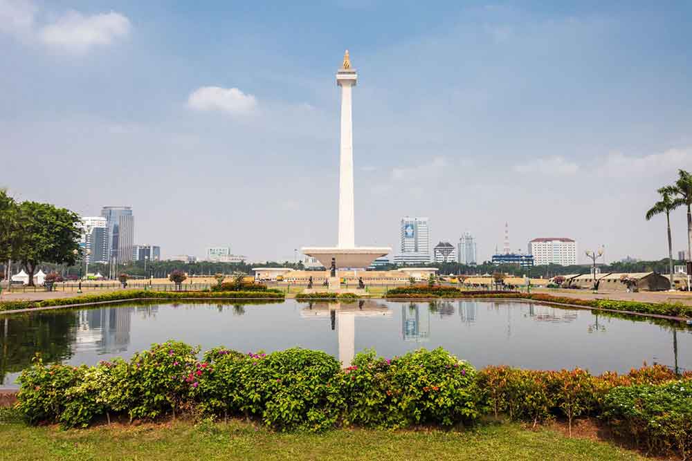 Tugus Monas, West Java featuring a towering obelisk-shaped monument surrounded by well-maintained gardens and pond