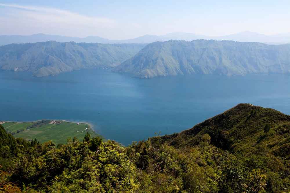 Lake Toba with its stunning view of the blue water, mountains and trees