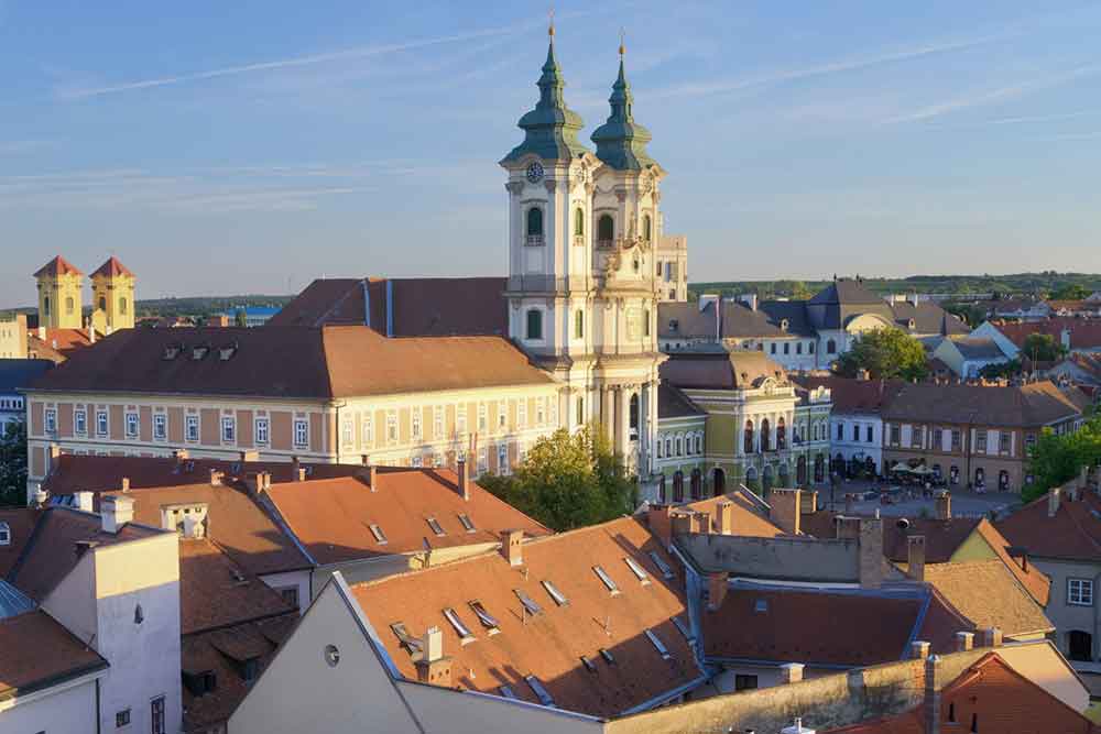 Castle of Eger, Hungary with its two tall towers surrounded by houses on a sunny day