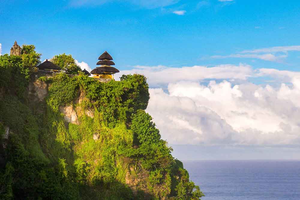 Uluwatu Temple perched on a cliff, overlooking the ocean in Bali, Indonesia