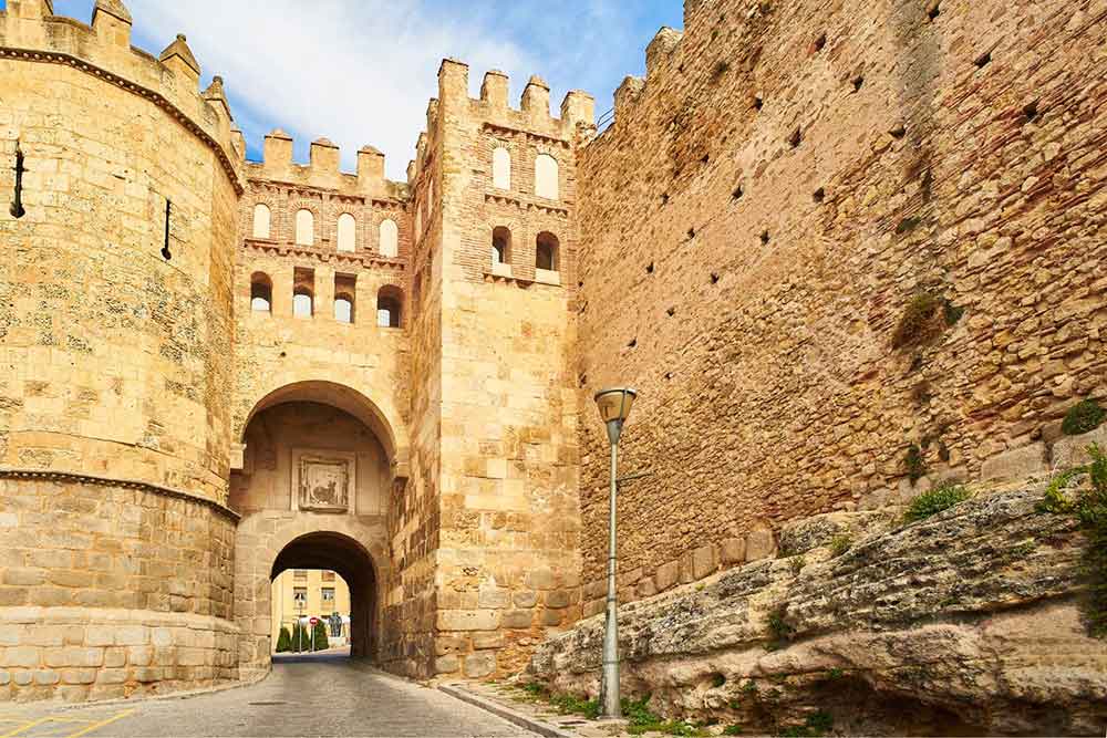 Is Segovia Worth Visiting? How to Visit Segovia From Madrid in a Day 12 Puerta de San Andreas, the only gate and entrance to the Jewish Quarter of Segovia featuring a sandstone walls and bricks