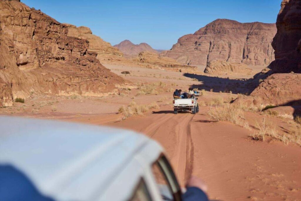7 Best Wadi Rum Jeep Tours, Jordan: Choosing the Best 4x4 Wadi Rum Experience 12 Tourists are riding in a Jeep 4x4 at Wadi Rum Desert