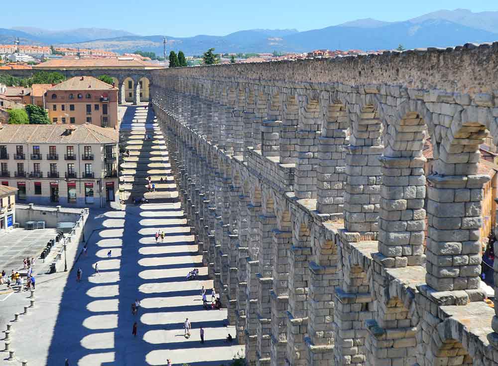Is Segovia Worth Visiting? How to Visit Segovia From Madrid in a Day 1 Aqueduct of Segovia composed of a series of towering arches made of massive stone blocks - a granite structure