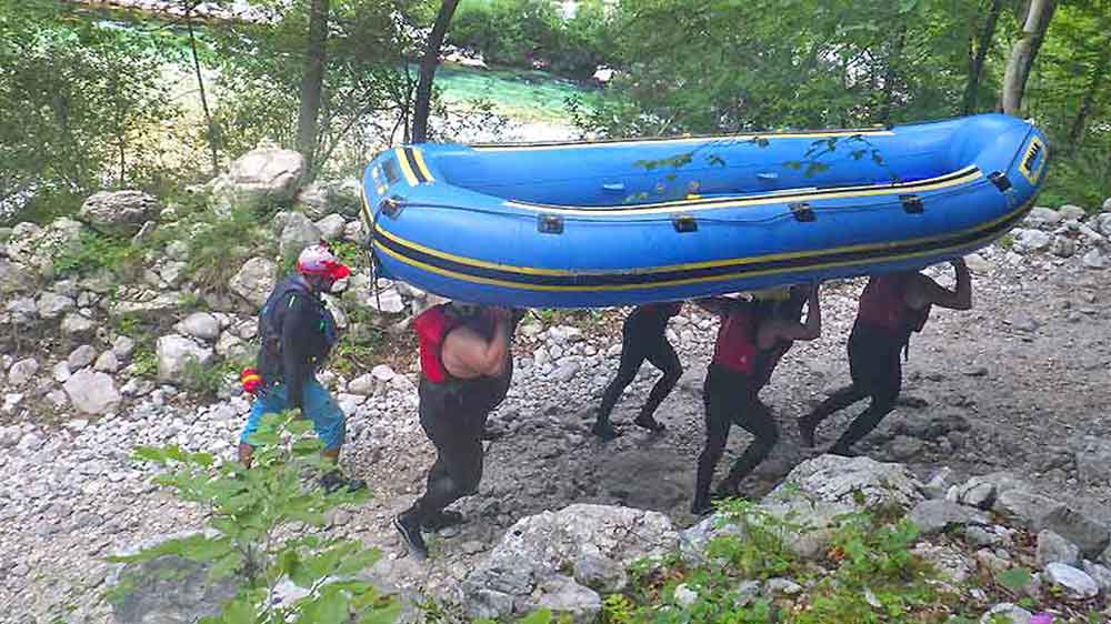 Group of people carrying the raft up at Slovenia