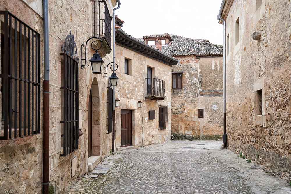 Is Segovia Worth Visiting? How to Visit Segovia From Madrid in a Day 10 Wander the cobbled streets at Segovia with old city walls and ironwork windows and balcony