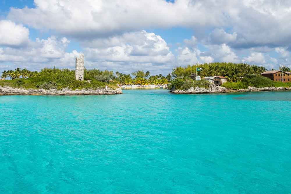 33 Best Hidden Coves and Secluded Beaches Around the World 9 Blue Lagoon Island in Bahamas showcases its teal color water surrounded by islands with a small entrance at the center
