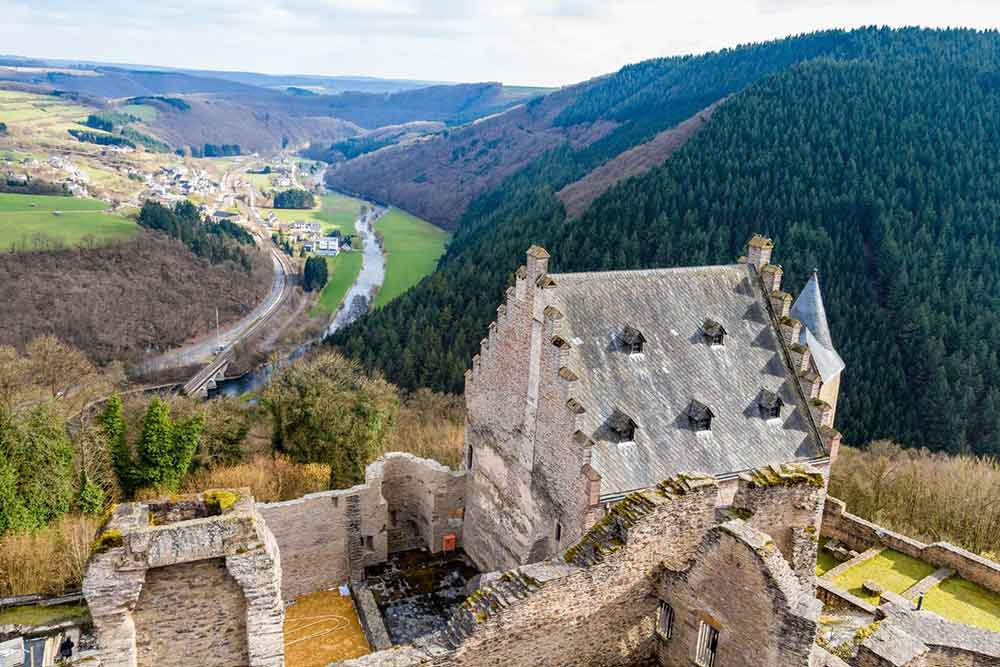 Bourscheid Castle on a hill overlooking the valley below