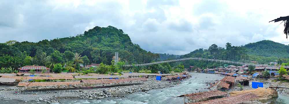 Bukit Lawang Jungle Trekking, Sumatra Orangutan Tour: How to See Bukit Lawang Orangutans 4 Aerial view of the town of Bukit Lawang on the Bahorok River with the Gunung Leuser National Park in the distance