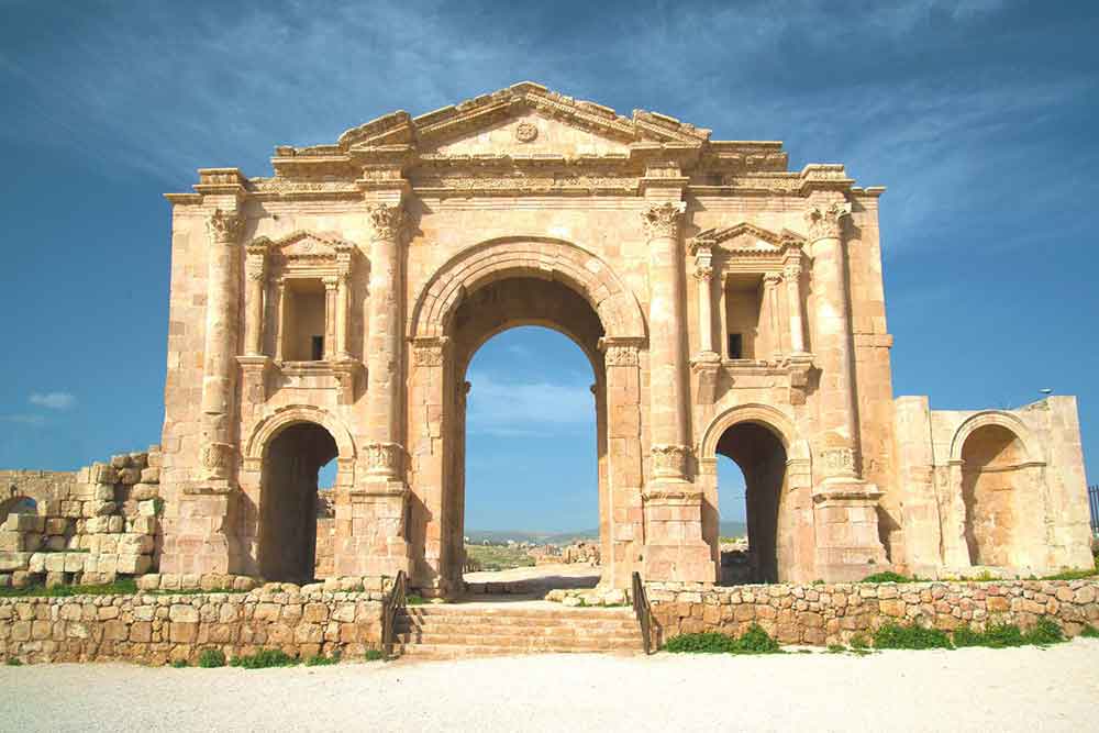 Hadrian's Arch features a triumphal arch with a central opening and smaller openings on the sides, adorned with decorative elements made of sandstone and bricks