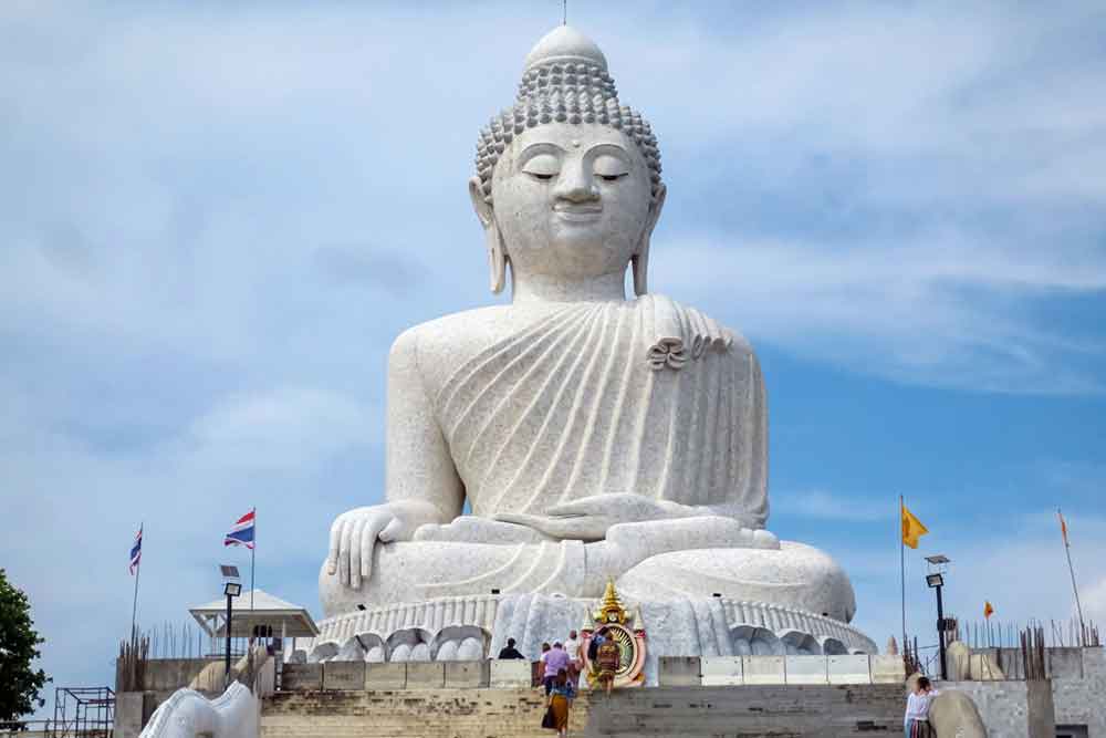A white Big Buddha Statue in Phuket, Thailand, stands majestically against a backdrop of a clear blue sky - Phuket How to Pronounce