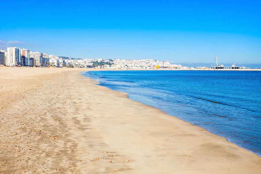 Tangier City Beach in Tangier, Morocco Tangier City Beach in Tangier, Morocco, with its blue waters meeting the brown sands, and buildings in the background