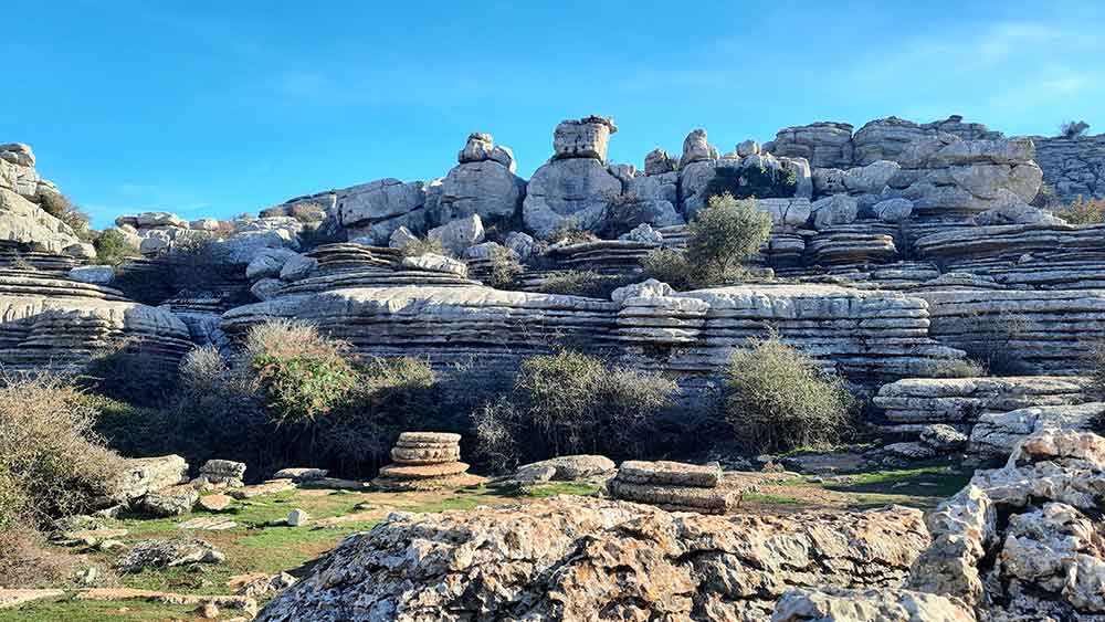 Rock formations of the karsts at Torcal de Antequera Natural Park showing light grey rocks made up with layers and unusal shapes.