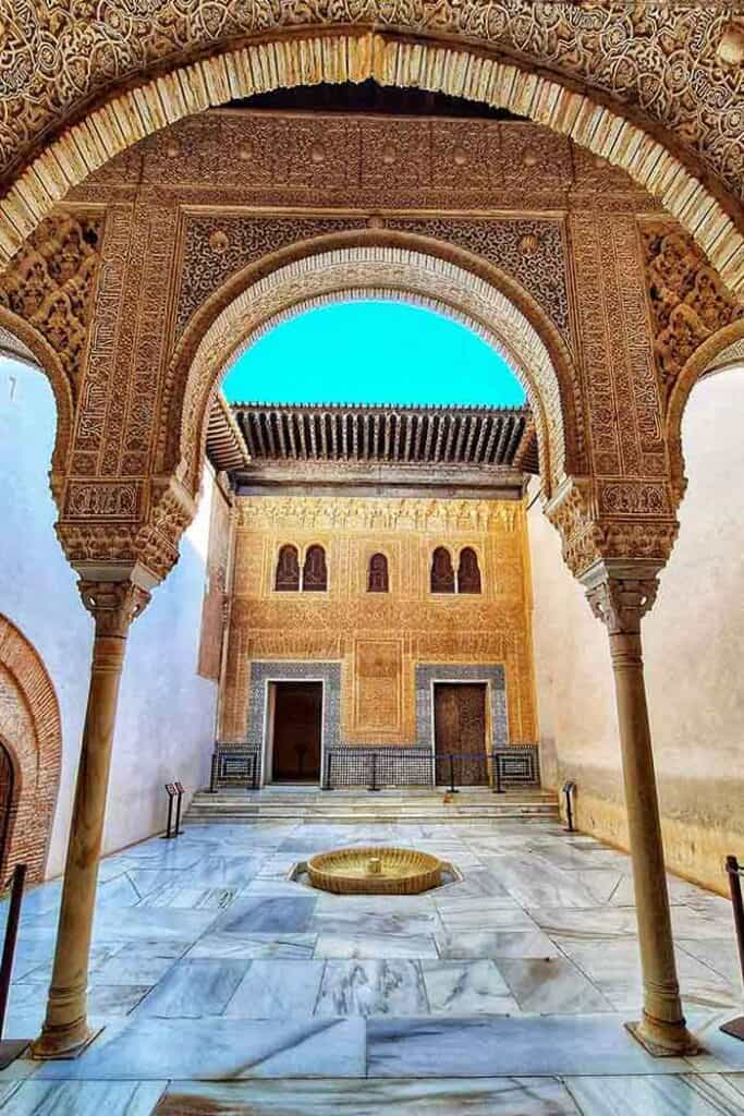 Beautiful intricate gold ceilings and arch in one of the Nasrid Palaces in Granada Spain