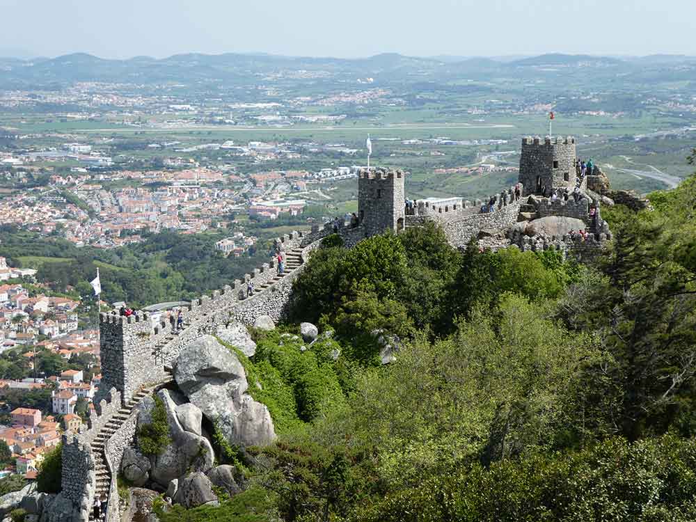 the Castelo dos Mouros with an undulating wall which you can walk along. There are toweres spaced out along the wall and it over looks small towns and villages below.