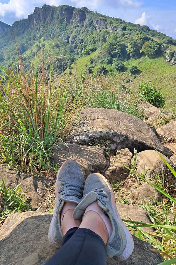 View of the Hanthana Mountain Range after an early morning hike. The mountains are in the background and my feet are in the forground.