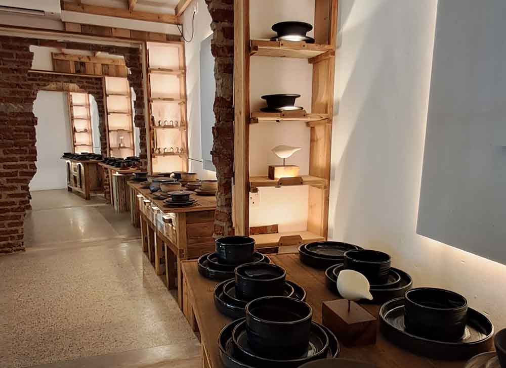 Various pieces of pottery including plates, bowls and ornaments on display at the Craft Tunnel