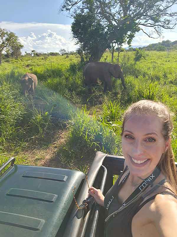 Travel Photo Book Ideas, Layouts, and Common Mistakes 8 Traveller (me) posing with elephants at Hurulu Eco Park in Sri Lanka. This makes a standout moment for a travel keepsake book.