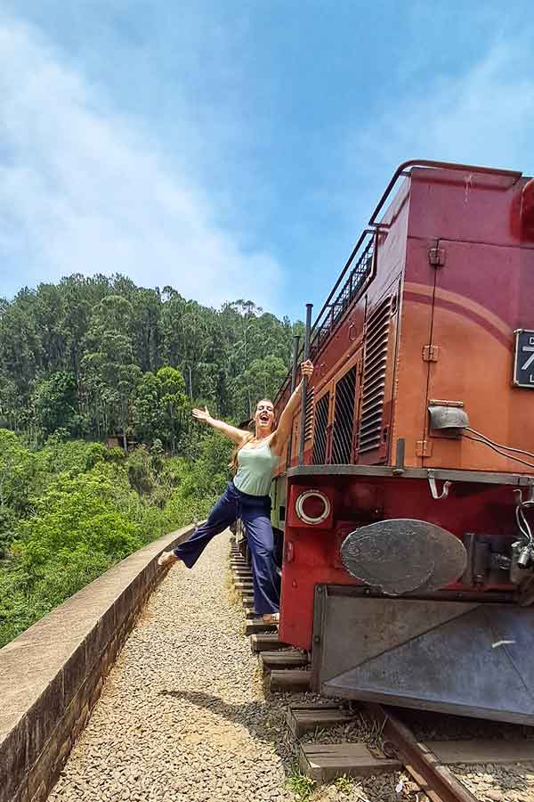 Me hanging off the front of the train in Kandi at Nine Arches Bridge