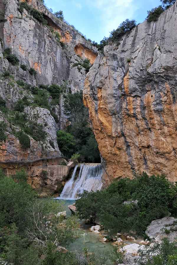 An Epic 5 Days Road Trip in Aragón Itinerary 27 A small waterfall into a river with cliffs on each side on the Walkway of Alcazar.