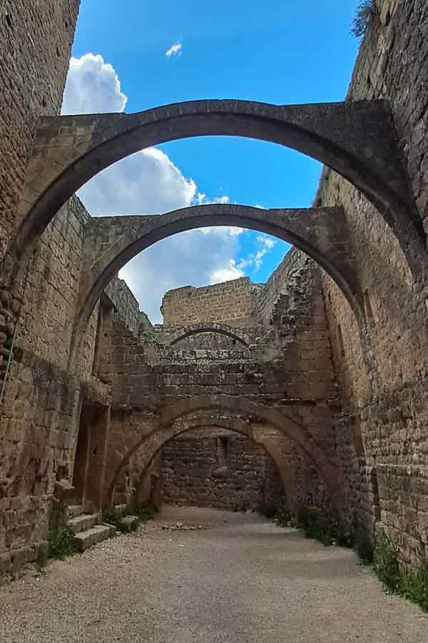 Inside the ruins of Loarre's Castle with the remnants of a series of arches that once supportd a ceiling. Only the arches remain.