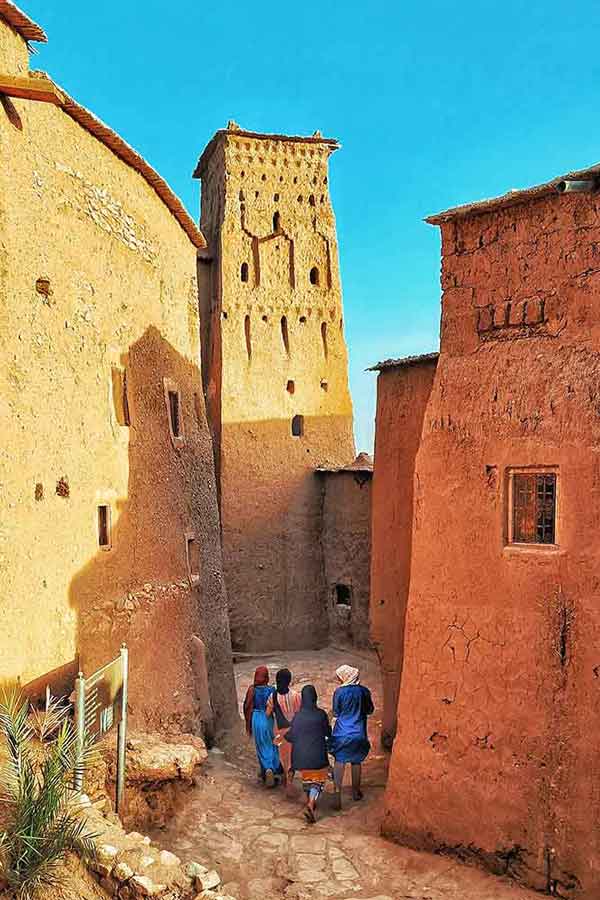 Women dressed in traditional Moroccan clothing at Ait Benhaddou