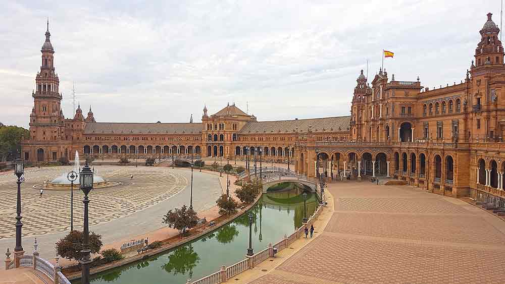 Plaza de Espana in Seville with a moat running parallel to it.