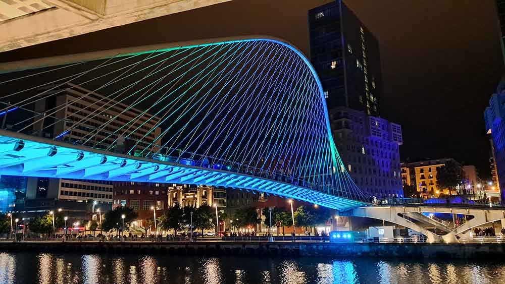 Zubizuri Bridge illuminated at night.