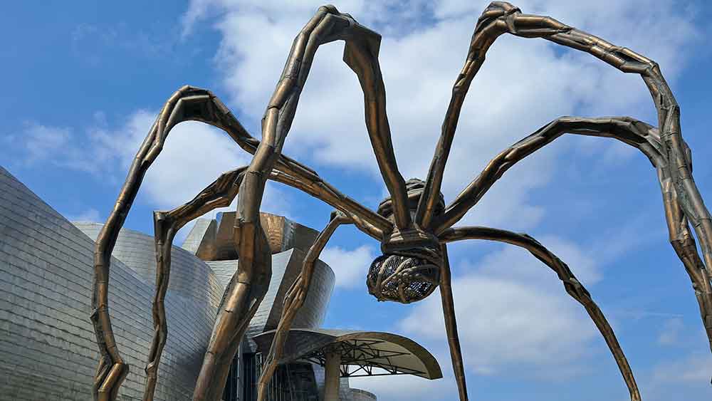 A towering spider sculpture outside the Guggenheim Museum in Bilbao, an iconic nearby destination often visited alongside San Sebastian and influential in shaping perceptions of what San Sebastian is known for in the broader Basque region.