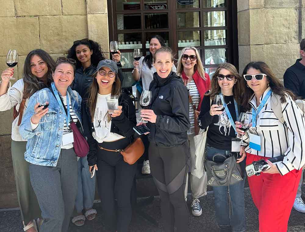 A cheerful group of women raising glasses of wine during a pintxos and wine tour in San Sebastian, highlighting the social food scene that many consider central to what San Sebastian is known for.