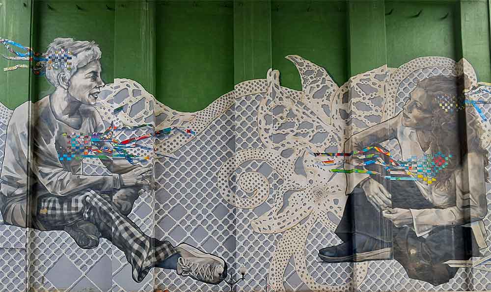 A gigantic mural called "Giltza" of two women talking on a lace like deailed background.