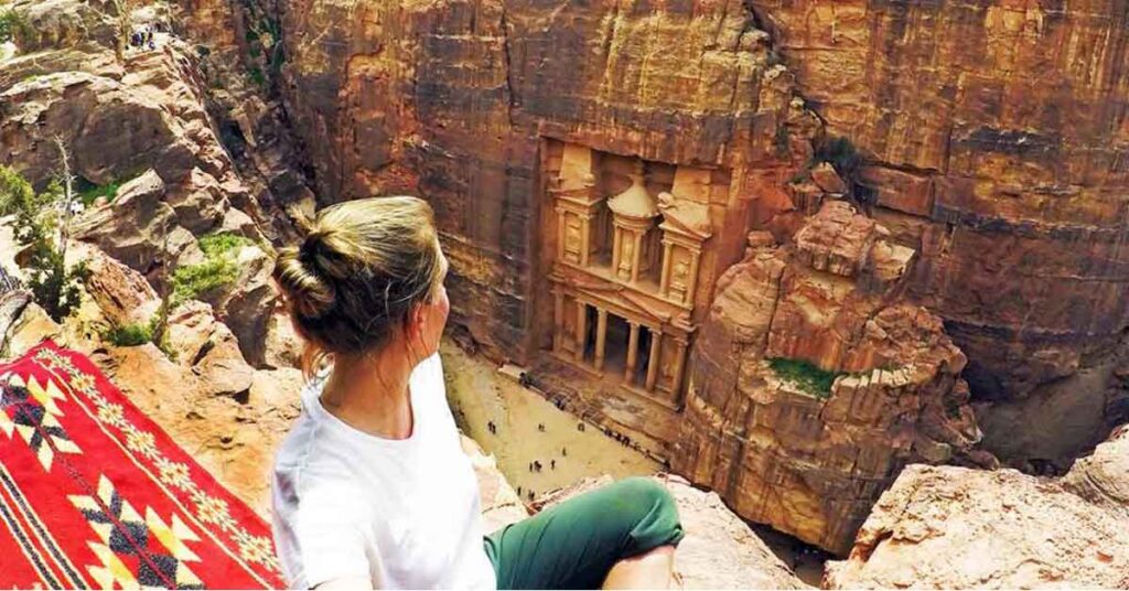 what to wear in Jordan as a woman view of a woman looking down on the treasury in Petra