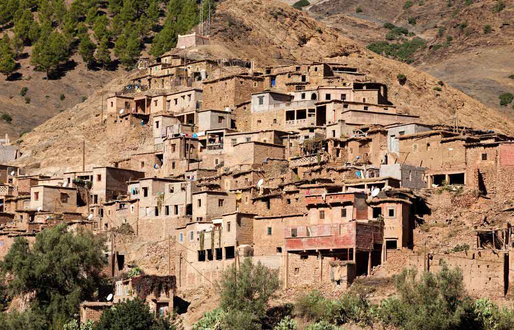 Berber Village in the Atlas Mountains – A traditional Berber village nestled in the rugged Atlas Mountains near Marrakech, Morocco. Exploring these remote villages offers a cultural and scenic experience, making it one of the best things to do in Marrakech for adventure seekers